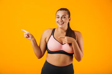 Poster Portrait of a cheerful overweight fitness woman © Drobot Dean