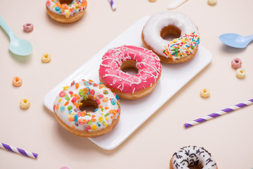 Preparation for the holiday. Colorful american donuts on pink background
