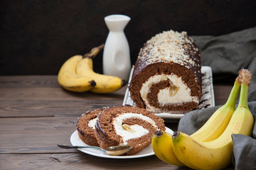 Homemade chocolate roll cake with mascarpone cream, bananas feeling, decorated with chocolate ant walnuts.