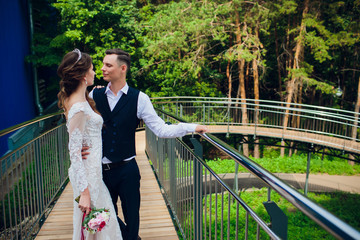 Bride and groom walking in the city, wedding day, marriage concept. Bride and groom in urban...