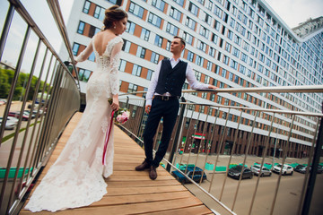 Bride and groom walking in the city, wedding day, marriage concept. Bride and groom in urban...