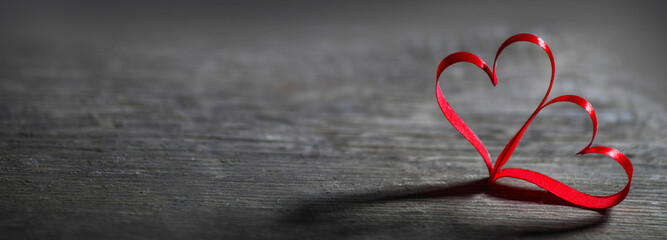 Two ribbon hearts on wood