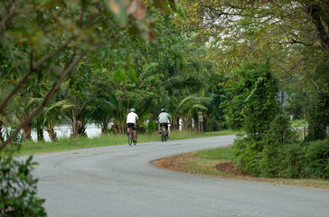 Two man exercise with biking in the public park.