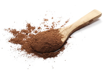 Cocoa powder pile with wooden spoon isolated on white background