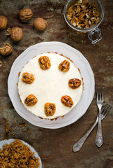 Carrot and walnut cake with cream cheese frosting. Top view.