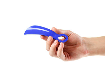 Hand holding blue Shoe spoon. Close up. Isolated on white background