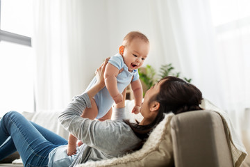 family and motherhood concept - happy young asian mother with little baby son at home