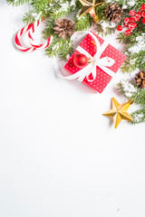 Christmas background with present and decorations on white.