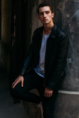 Attractive, sexy guy standing on the street in sunglasses. self-confidence, flatulence and arrogance. model, posing, portrait of a young man