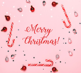 Merry Christmas text on pink background with christmas decorations
