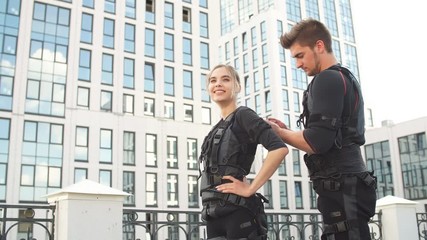 Awesome smiling blond woman is going to work out with ems costume. Grown ups are good at sport