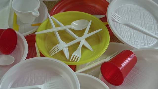 colorful plastic disposable tableware rotating background