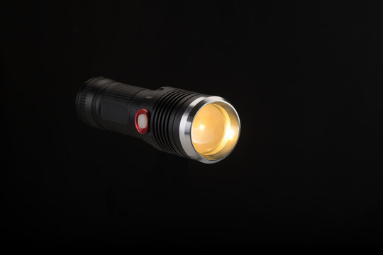 Tactical flashlight on a black background