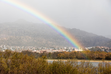 Arcoiris in the Santillana reservoir and the city of Manzanares el Real in Madrid