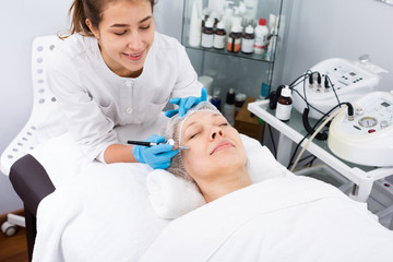 Mature woman having beauty procedures