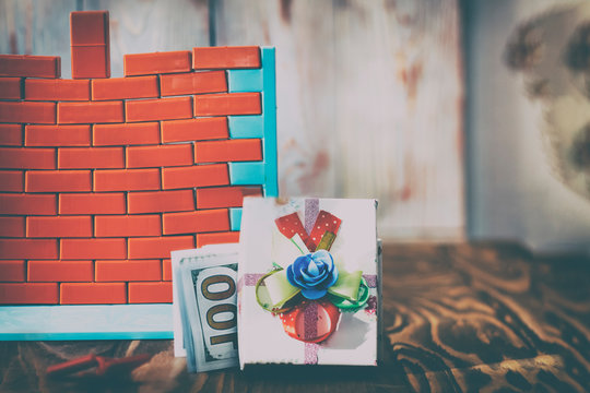 wall toys and red bricks. have toning. The concept of real estate purchase and completion of construction. No money and no opportunity to complete construction