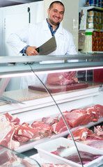 Male butcher in kosher section at supermarket