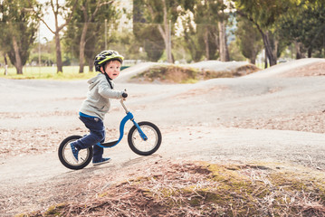 Kid riding his balance bike