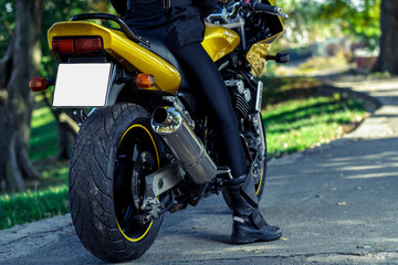 Fototapeta na wymiar Girl on a yellow motorcycle
