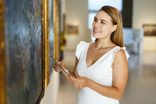 Woman visiting painting exhibition