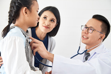 Young woman and her little daughter with pediatrician