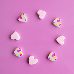 Obraz premium Valentine's Day concept - close up frame of hearts. Pink background. Copy space for text. View from above.
