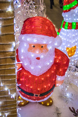 Christmas Santa Claus shining with lights. Glowing Christmas figures to decorate the entrance to the house. Christmas decorations