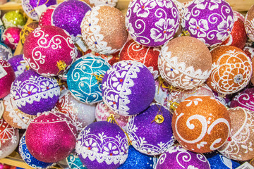 A full box of colorful brightly colored balls for the Christmas tree. group of objects. background of christmas balls
