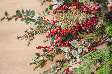 Christmas attributes pine cone and holly berries on the Christmas-tree branch.