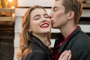 the guy kisses the smiling girl