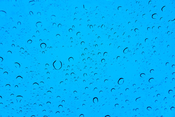 Fototapeta na wymiar Water Drops on blue background.Selective Focus.Visible Noise due to High ISO