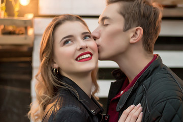 the guy kisses the smiling girl