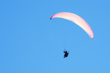 Paraglider against the sky. Russia, Republic of Crimea. 06.13.2018. Flight of a paraglider athlete against the sky