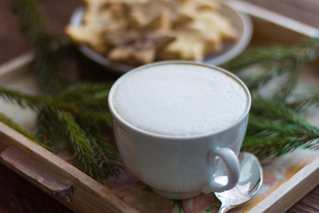 Obraz na płótnie Canvas a Cup of coffee with a thick foam and Christmas cookies with sugar and cinnamon