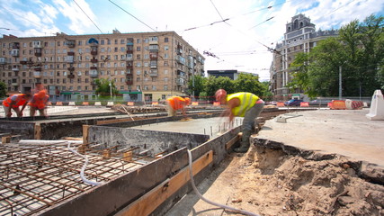 Concrete works for road maintenance construction with many workers and mixer timelapse hyperlapse