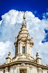 The dome of Sant Ivo alla Sapienza against the backdrop of an incredible blue sky with fluffy white clouds. Rome. Italy