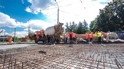 Concrete works for road construction with many workers and mixer timelapse hyperlapse