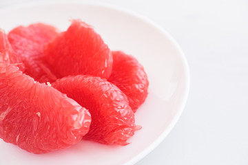Red Grapefruit slices on a plate