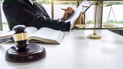 Law, lawyer attorney and justice concept, male lawyer or notary working on a documents and report of the important case in the workplace office