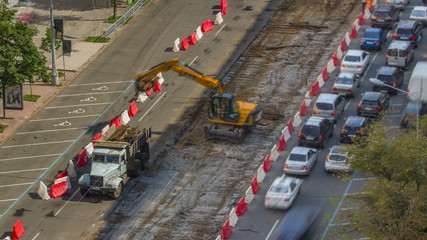 Industrial truck loader excavator moving earth and unloading into a dumper truck timelapse