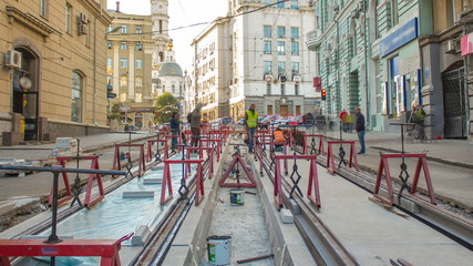 Tram rails at the stage of their installation and integration into concrete plates on the road timelapse.