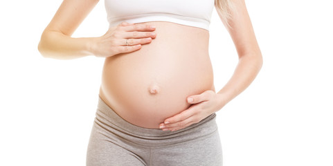 Close-up of pregnant woman touching her belly