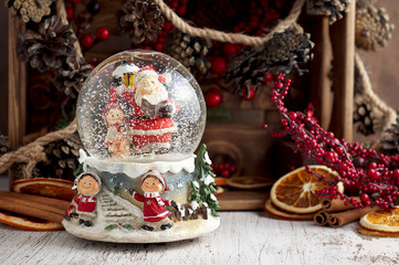 Musical Snow Globe with Santa Claus on wooden background