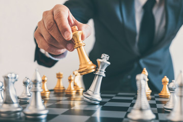 Businessman leadership playing chess and thinking strategy plan about crash overthrow the opposite team and development analyze for successful of corporate