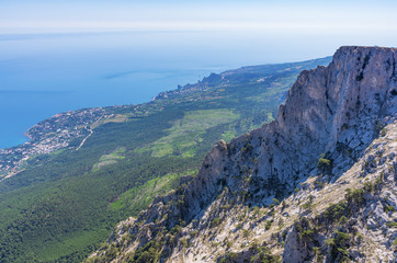 Fototapeta na wymiar View from the top of the mountain to the seaside town d on the southern slope of the Crimean
