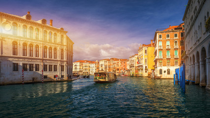 View of the street canal in Venice, Italy. Colorful facades of old Venice houses. Venice is a popular tourist destination of Europe. Venice, Italy.