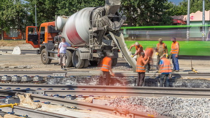 Pouring ready-mixed concrete after placing steel reinforcement to make the road by concrete mixer timelapse.