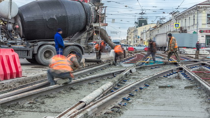 Pouring ready-mixed concrete after placing steel reinforcement to make the road by concrete mixer...