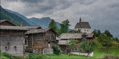Fototapeta na wymiar Panoramic view of a quaint Swiss mountain village in the rain