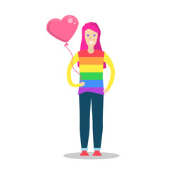 Young women wearing a rainbow t shirt and holding a heart shape balloon.